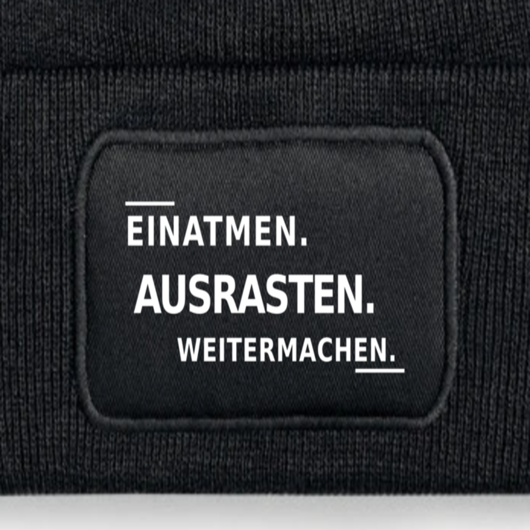 Detailansicht des Aufdrucks EINATMEN. AUSRASTEN. WEITERMACHEN.