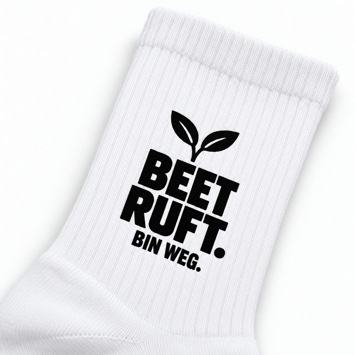 Detail des schwarzen Motivdrucks BEET RUFT. BIN WEG. auf geripptem weißem Schaft