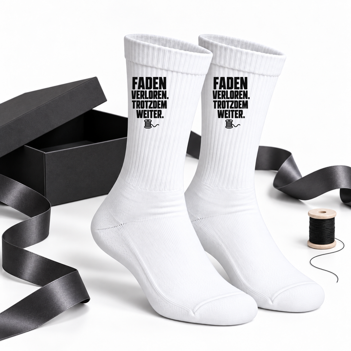 Näh-Socken als Geschenkidee neben schwarzer Geschenkbox