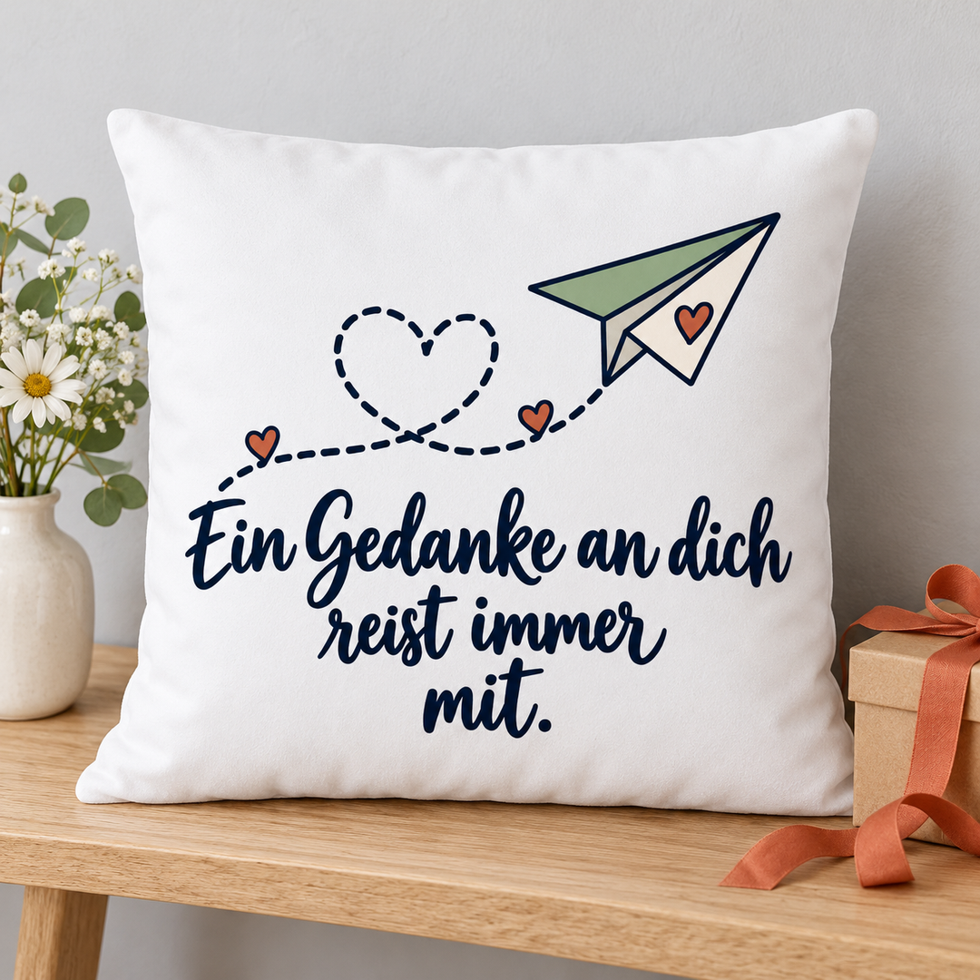 Liebeskissen mit Papierflieger als Geschenk neben einer Geschenkbox