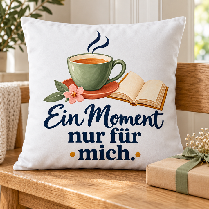 Weißes Auszeit-Kissen als Geschenk neben einem verpackten Buch