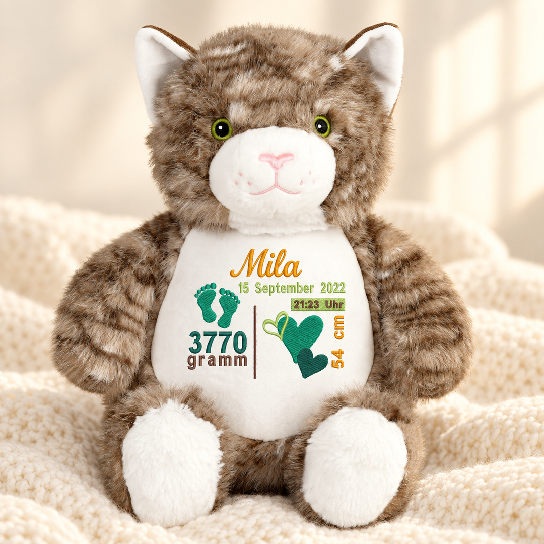 Personalisiertes Kuscheltier Cat mit Name & Geburtsdaten – Beispiel Mila auf cremefarbener Decke