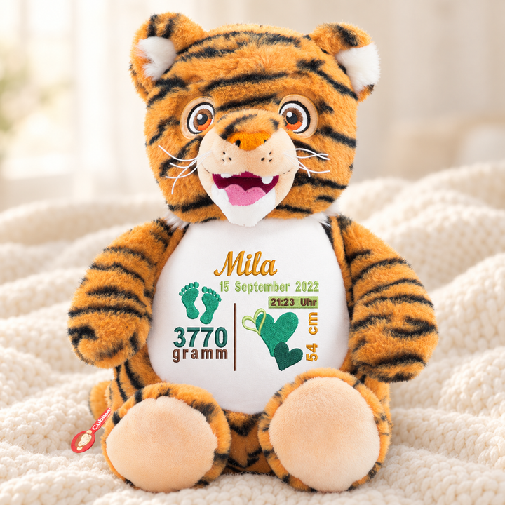 Personalisiertes Kuscheltier Baby Tiger mit Name &amp; Geburtsdaten – Beispiel Mila auf cremefarbener Decke